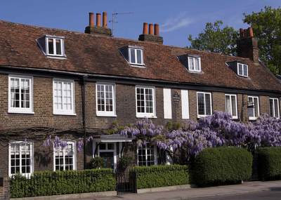 Peg Woffington's cottages in Teddington High Street in the spring with wisteria in flower in Middlesex in the United Kingdom