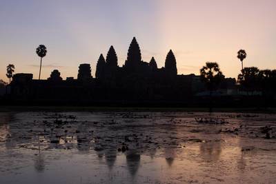 Sunrise at Angkor Wat viewed from inside the outer walls, eastwards over the central temple complex, a temple complex built for king Suryavarman II in the early 12th century as his state temple and Khmer capital city near Siem Reap in Cambodia