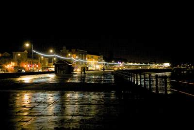 Lights decorating the Penzance promenade in Cornwall, United Kingdom at night in the rain in winter