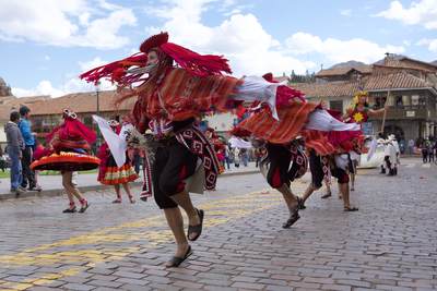 Many people from local towns and groups dressed in fancy dress and traditional costumes participate in the 'Tourism Festival' passing through Plaza de Armas in Cusco in Peru in South America