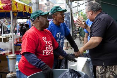 Two street workers chatting at the Hells Kitchen annual food festival in mid Manhattan in New York City in the United States of America USA U.S.A
