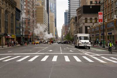 New York City street in Manhattan with steam and a large lorry truck in the United States of America USA U.S.A.