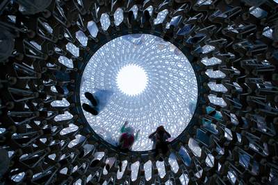 View up through the Interactive sculpture 'The Hive', a unique structure, inspired by scientific research into the health of bees. Designed by UK based artist Wolfgang Buttress, originally created as the centrepiece of the UK Pavilion at the 2015 Milan Expo. The installation is made from thousands of pieces of aluminium which create a lattice effect and is fitted with hundreds of LED lights, within the botanic gardens of Kew in London in United Kingdom