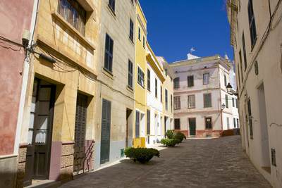 Colourful houses in the back streets of the old part of Ciutadella in Menorca , part of the Balearics in Spain Europe 