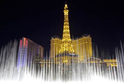 View of the Paris hotel and replica Eiffel tower through the Bellagio fountains at night in Las Vegas Boulevard (The Strip) in Nevada, United States of America U.S.A. USA
