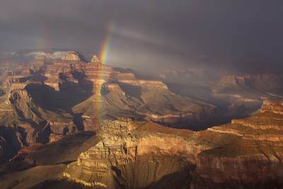 A storm at sunset creates a double rainbow over Plateau Point viewed from Yavapai Point on the South Rim of the Grand Canyon in Arizona  in the United States of America, USA U.S.A.