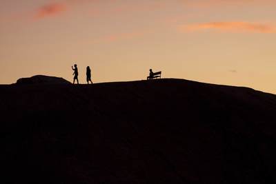 Silhouetted visitors at Zabriskie Point after sundown in Death Valley in California in the United States of America in the USA U.S.A.