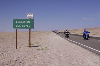 Motorcyclists on Highway 190 heading towards Furnace Creek Resort in Death Valley - elevation at sea level in California in the United States of America in the USA U.S.A.