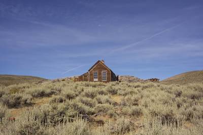 Deserted gold miner's house in Bodie with the moon above - a deserted gold mining town started in 1859 and after many boom and bust times, finally deserted in 1943 in California in the United States of America in the USA U.S.A.