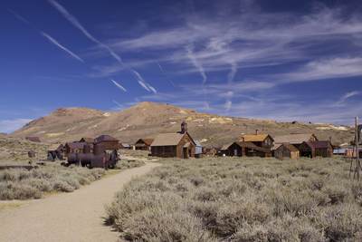 View of the town of Bodie with spoil heaps beyond - a deserted gold mining town started in 1859 and after many boom and bust times, finally deserted in 1943 in California in the United States of America in the USA U.S.A.