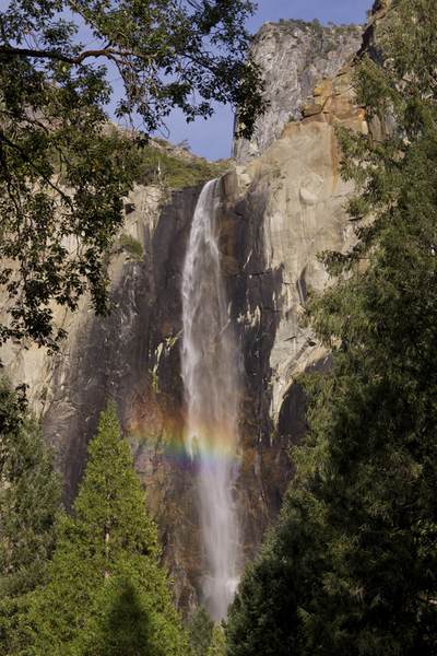 Bridalveil Falls fed by Bridalveil Creek (188 metres, 617 feet high) which flows year round, with a rainbow formed by spray rising from the bottom of the falls in Yosemite National Park in California in the United States of America in the USA U.S.A.