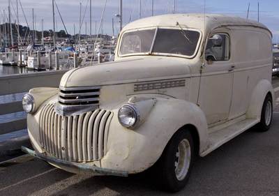 Vintage Chevrolet van parked on the harbour side at Monterey marina in California in the United States of America USA U.S.A.