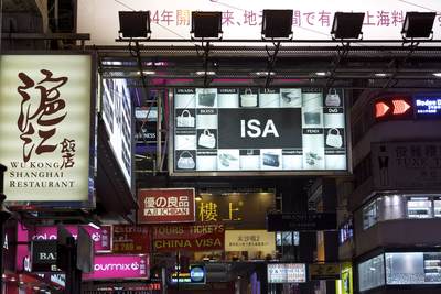 Neon signs advertising shops and restaurants along Nathan Road in Kowloon in Hong Kong