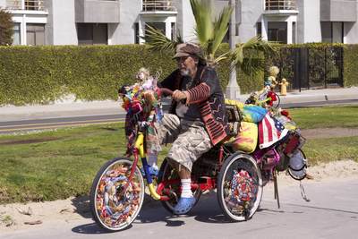 Man riding a customised and decorated bike on the cycle way alongside the boardwalk in Santa Monica in Los Angeles, California, United States of America USA U.S.A.