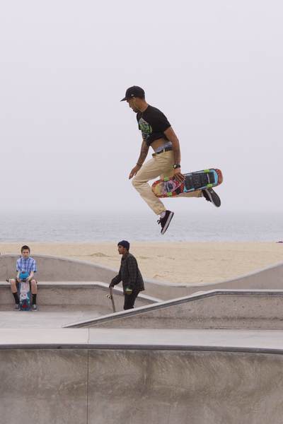 Skateboarder practicing moves at Venice Beach Skate Park on a foggy day in Los Angeles, California, United States of America USA U.S.A.