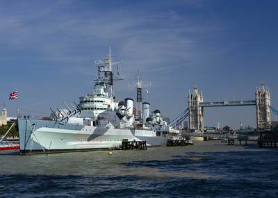 HMS Belfast moored on the South Bank of the river Thames with Tower Bridge in the background in central London in the United Kingdom