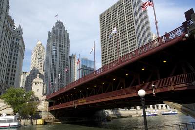View of the DuSable Bridge with flags flying above looking down Michigan Avenue in Chicago (Windy City) in Illinois in the United States of America USA U.S.A.