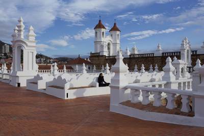 Rooftop view of the Church of San Felipe Neri (Oratorio de San Felipe de Neri) with views of the town of Sucre in the background in Bolivia in South America