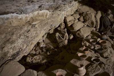 Skeletal remains of the 'Chullpas' - pre-Incan people - in an underground cemetery in the foothills of the volcano of Tanupa, along with offering/votive bowls in Salar de Uyuni Bolivia in South America