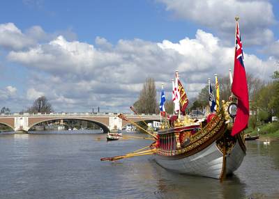The Gloriana on the river Thames at Hampton Court during the Tudor Pull, in East Molesey, Surrey in the United Kingdom