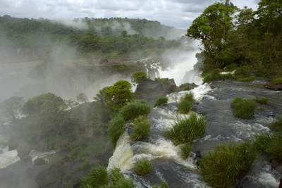 View over the Iguazu Falls - the largest waterfalls system in the world comprising of a number of cataracts with the Upper Iguazu River flowing over and forming the Lower Iguazu River below in Argentina in South America