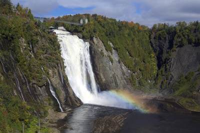 A rainbow at the bottom of the Montmorency Falls - a large waterfall on the Montmorency River in Quebec, the area surrounding the falls is protected within the Montmorency Falls Park, Quebec Province, Canada, North America