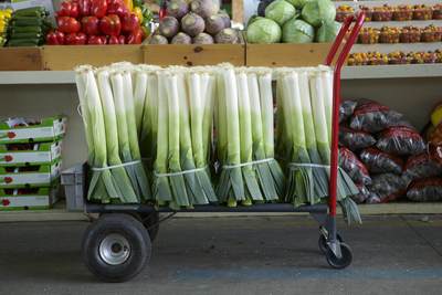 Farmers produce including leeks and garlic for sale at Jean-Talon Market (French -Marché Jean-Talon), a farmer's market located in the Little Italy district of Montreal in Quebec Province in Canada in North America