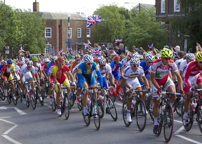 London Olympics 2012 - mens Road cyclists cycling through Teddington High Street in Middlesex in the United Kingdom