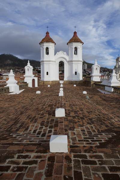 Rooftop view of the Church of San Felipe Neri (Oratorio de San Felipe de Neri) built from 1795 to 1799 with views of the town of Sucre in the background in Bolivia in South America