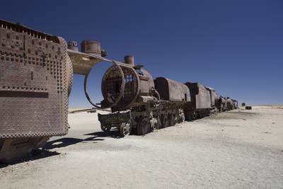 Rusting locomotives trains in the train cemetery, outside Uyuni and connected to it by old train tracks in Salar de Uyuni in Bolivia in South America