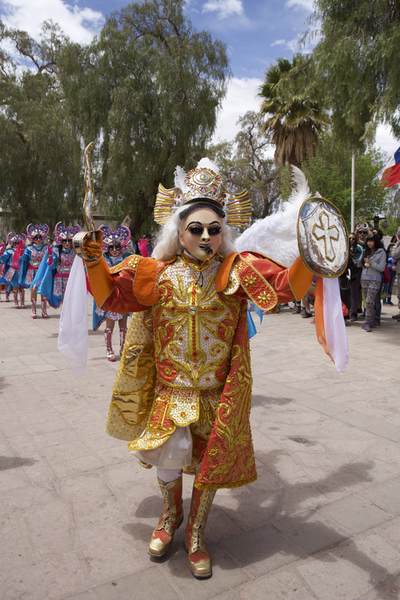 Costumed participants in the festival of 'Our Lady of the Rosary' dancing in the town square of San Pedro de Atacama in the Atacama desert in Chile in South America