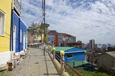 View of the colourful houses of Valparaiso overlooking the Chilean Naval ships in the harbour in Chile in South America