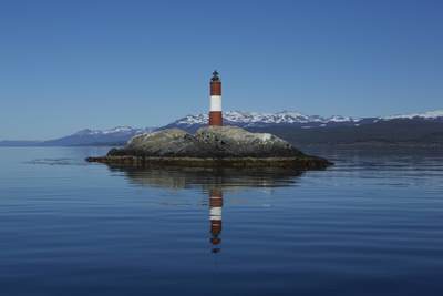 Les Eclaireurs Lighthouse reflected in the calm waters of the Beagle Channel, built in the 1920's and still in service today although remote-controlled, automated, and uninhabited in Ushuaia, Argentina in South America