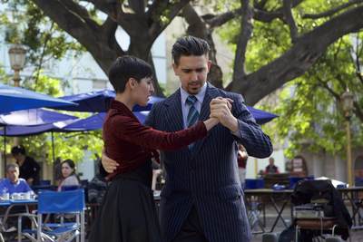 Two Tango dancers demonstrate classic dance moves outside in Plaza Dorrego and entertain onlookers, in the San Telmo district of Buenos Aires in South America